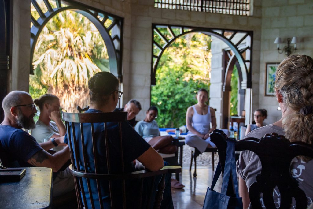 people seated in a circle participating in psychedelic integration at mycomeditations psilocybin retreat